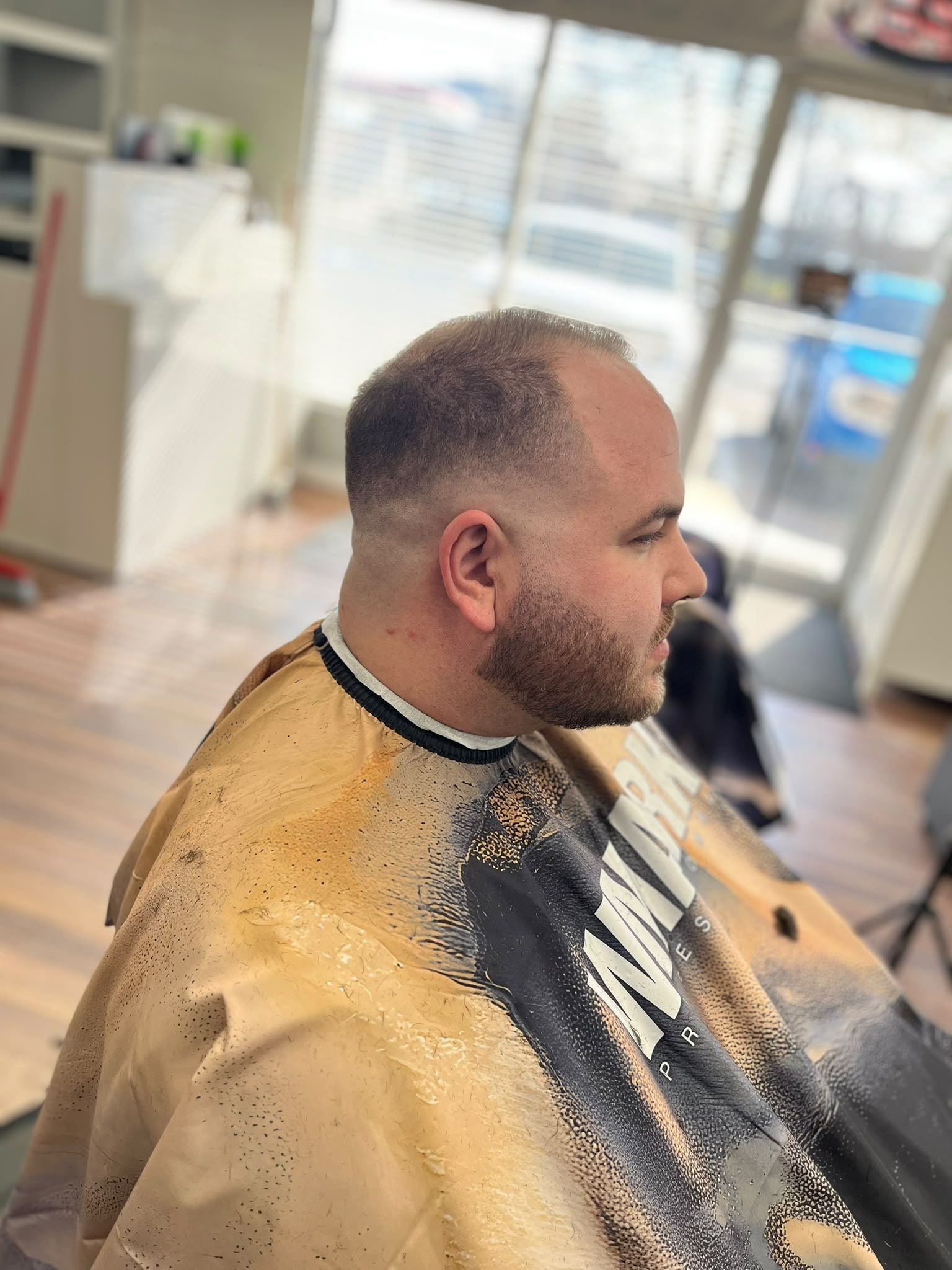 Buzz cut with a high skin fade and a short beard
