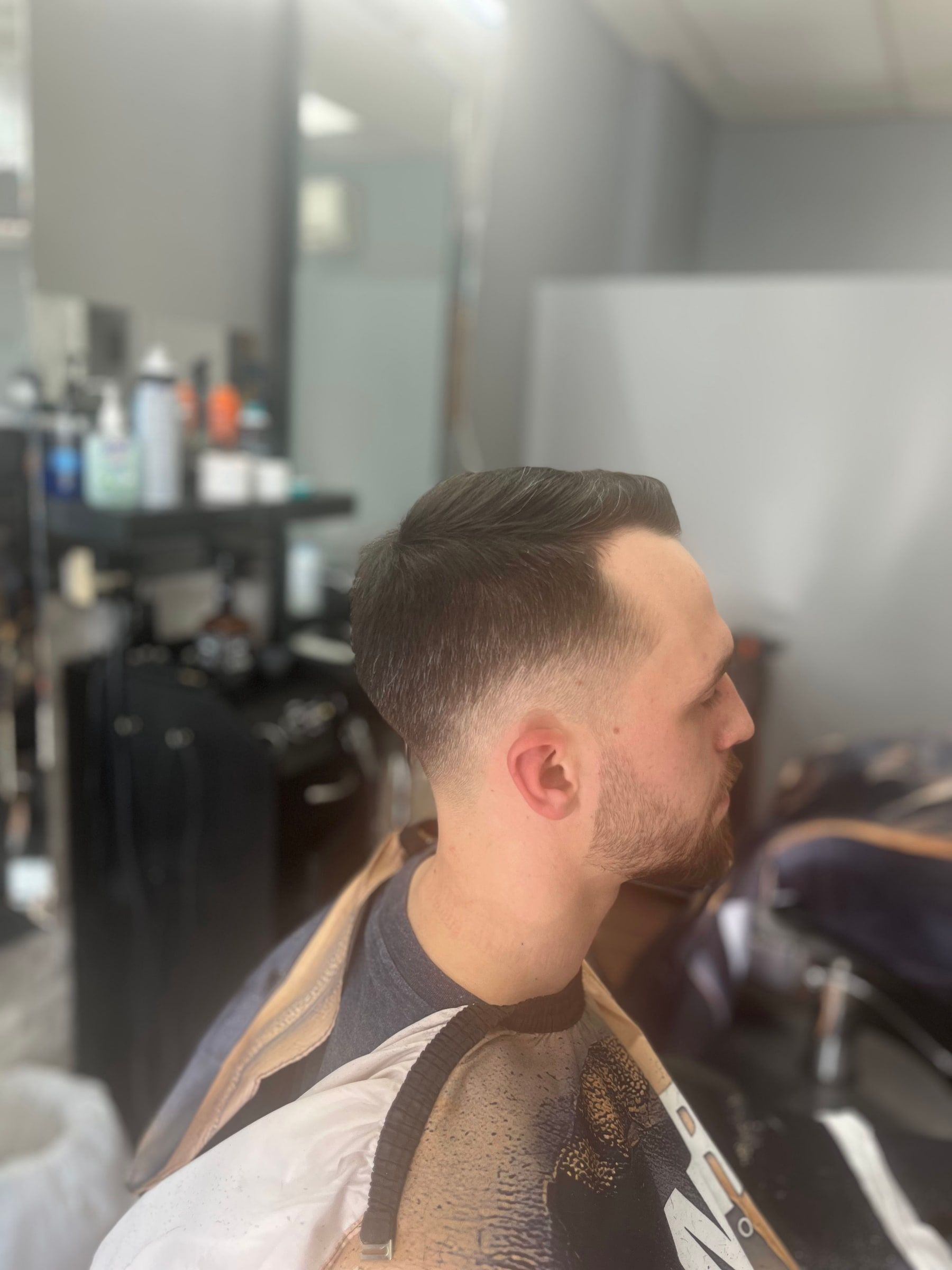 Taper fade with a side part, side view