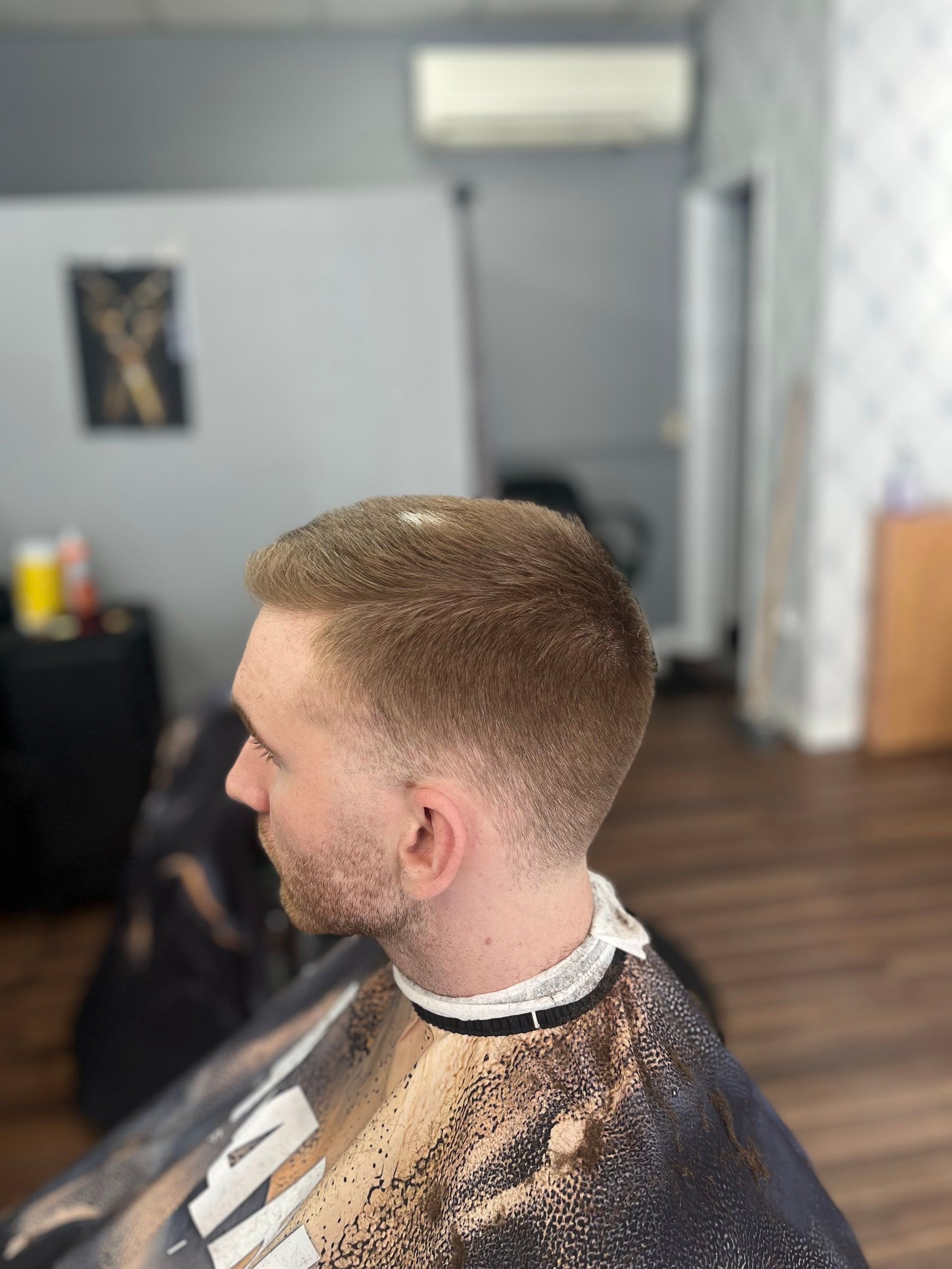 Short textured crop with a taper on ginger hair