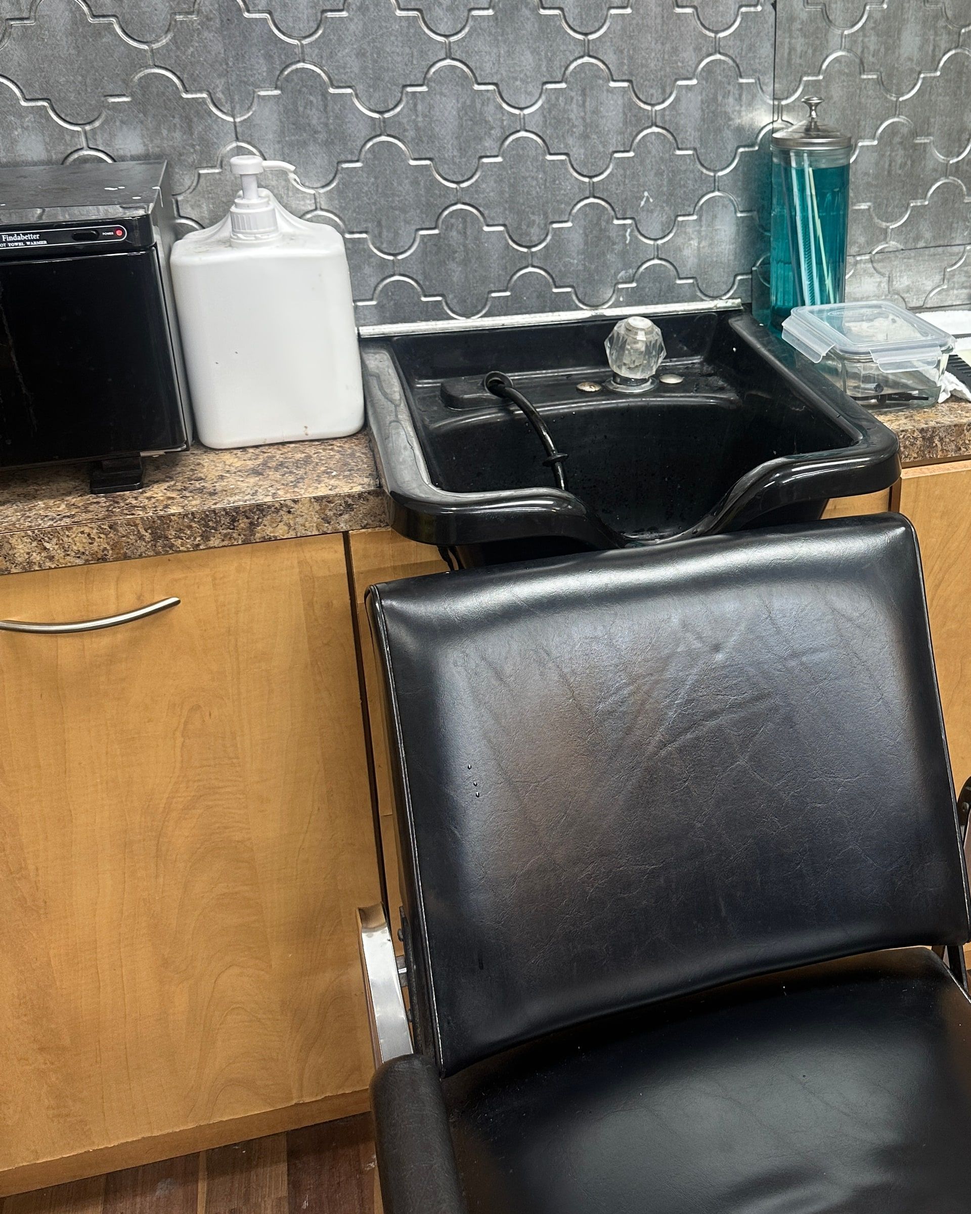 Wash station with a black basin chair